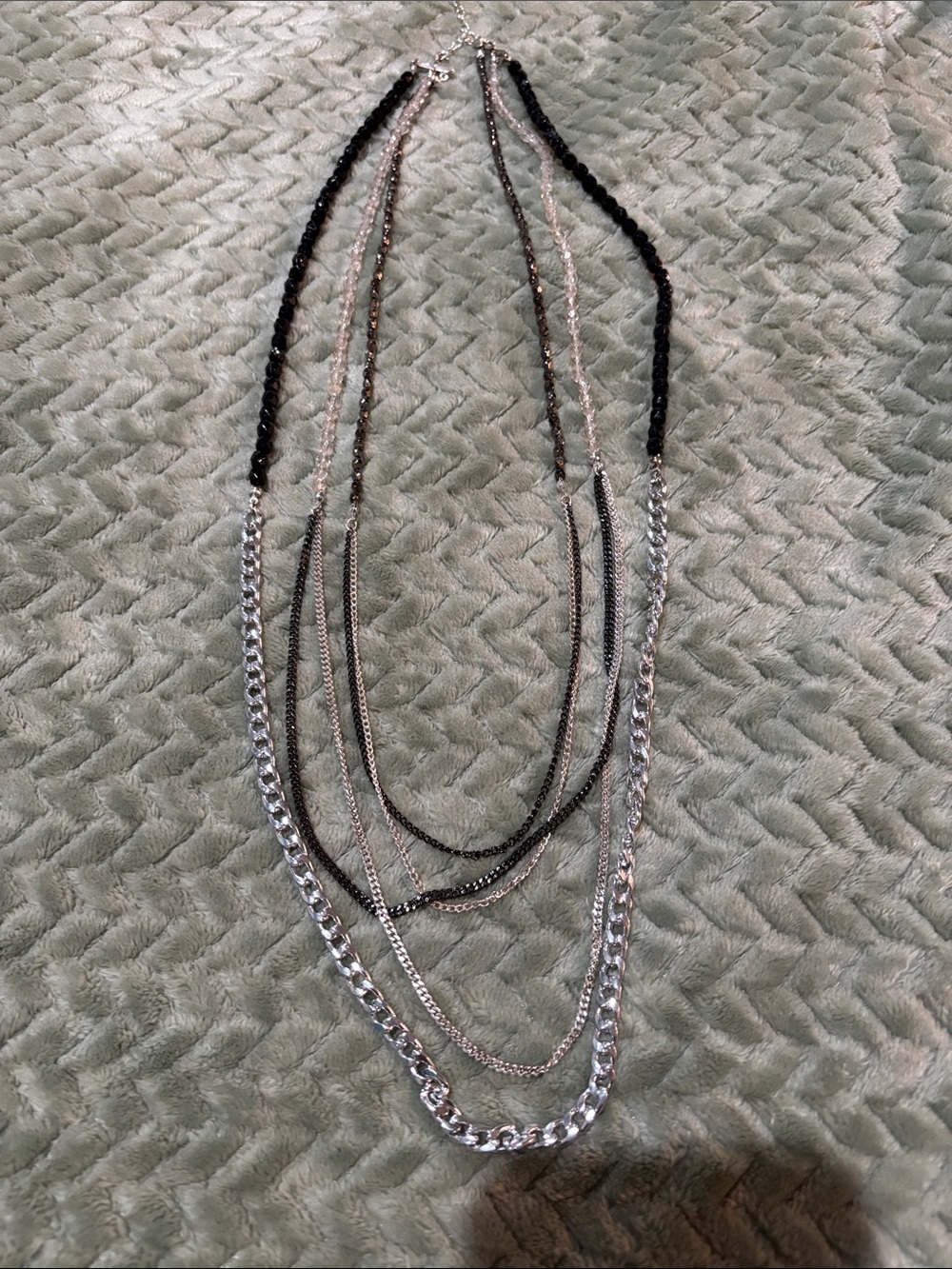 Beautiful long necklace with a mix of silver, black beads, lucite beads.